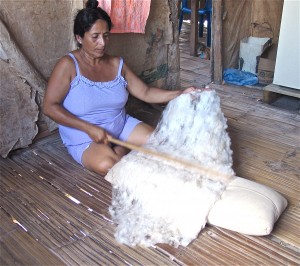 Beating the cotton into a fluffy sheet of interlocking fibers