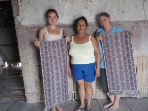 Amber and Janet with their instructor doña Trinidad show off their finished wall-hangings which are ready to hang. 